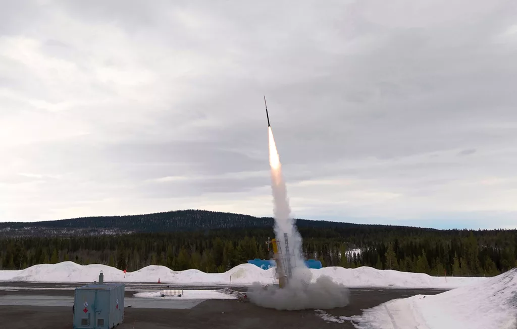 Rocket launch with forest in the background.