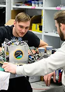 Students preparing a rocket payload.