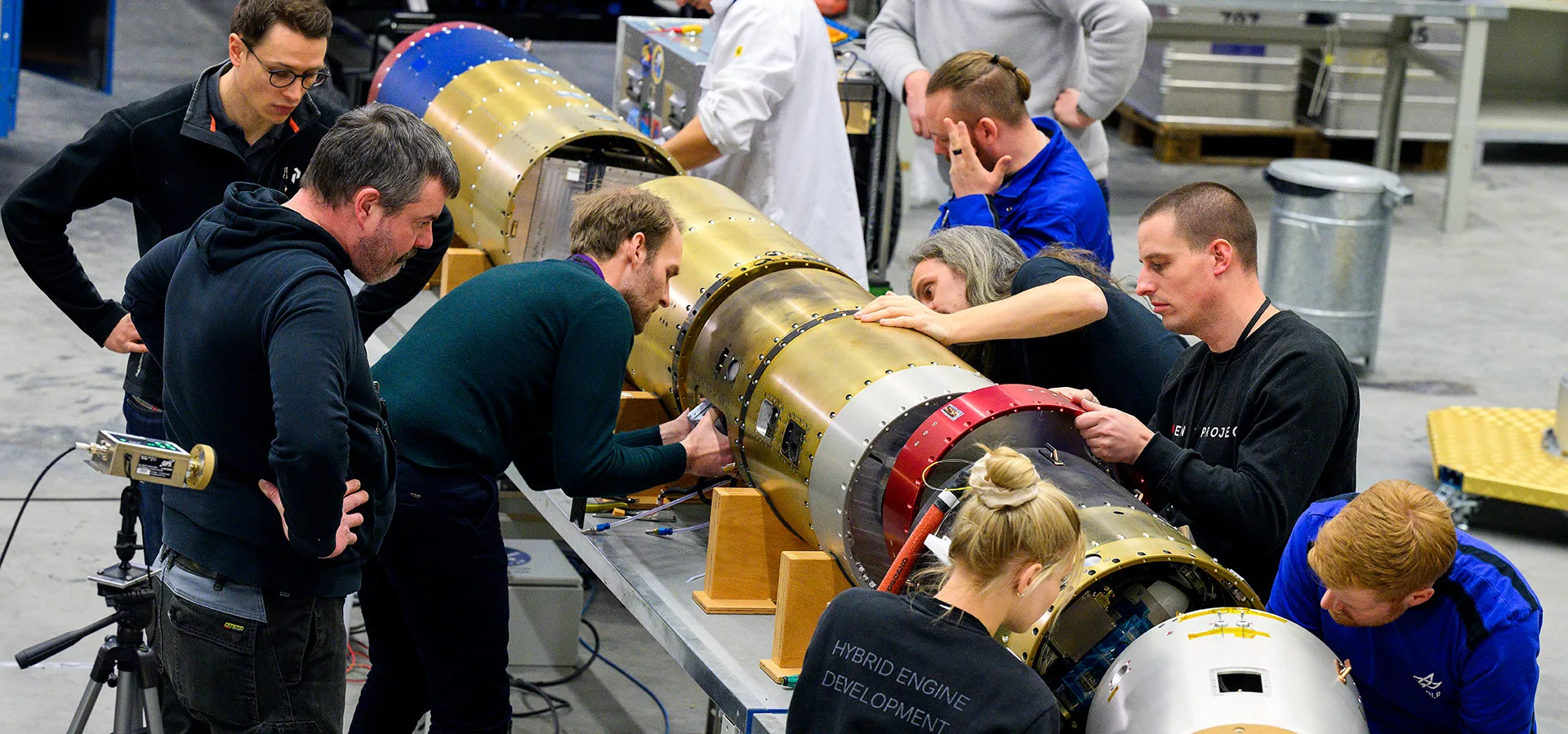 Several engineers working with rocket payloads