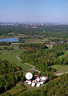 View over Stockholm Teleport with fields and the city in the background.